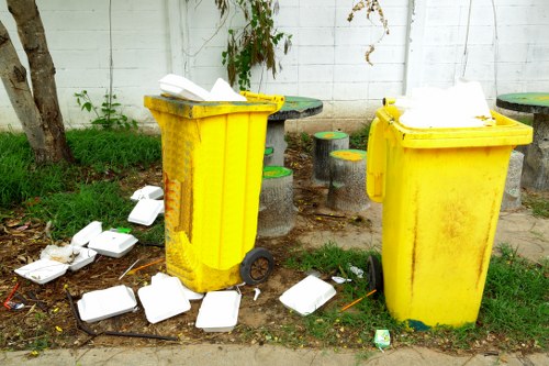 Workers managing builders waste clearance on a construction site
